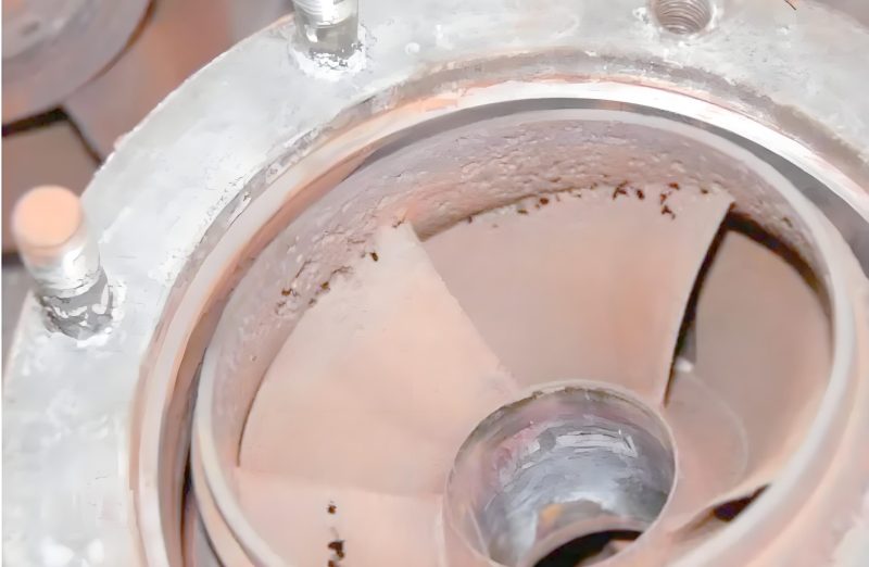 Cavitation damage on hydraulic component showing pitting caused by vapor bubble collapse in hydraulic fluid